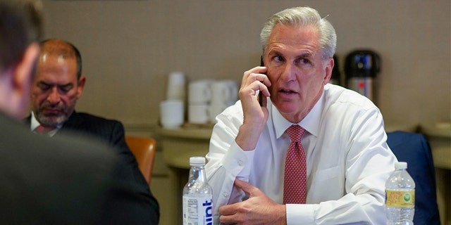 House Minority Leader Kevin McCarthy talks on the phone as he waits for election results in a room at the Madison Hotel in Washington, D.C., on Nov. 8, 2022.