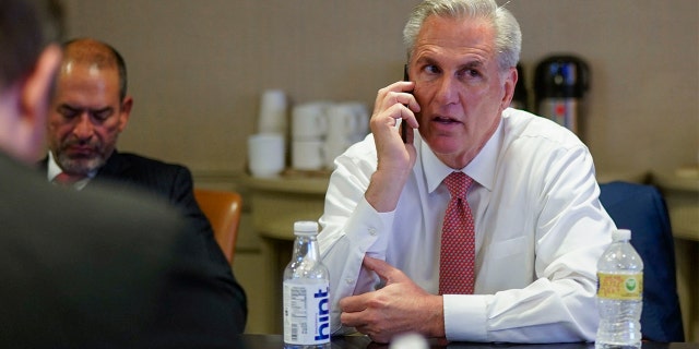 House Minority Leader Kevin McCarthy talks on the phone as he waits for election results in a room at the Madison Hotel in Washington, D.C., on Nov. 8, 2022.