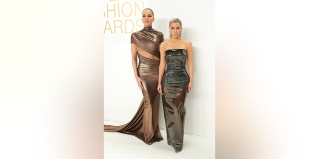 Khloe Kardashian wore a LaQuan Smith design while sister Kim Kardashian went for Dolce & Gabbana at the CFDA Fashion awards.