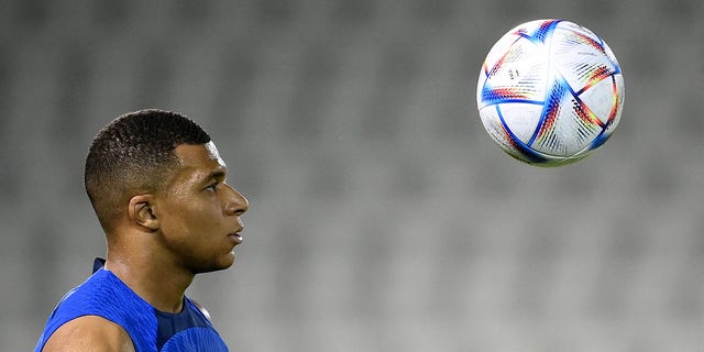 France's forward Kylian Mbappe eyes the ball during a training session at the Jassim-bin-Hamad Stadium in Doha, Qatar, on Nov. 17, 2022, ahead of the Qatar 2022 World Cup football tournament.