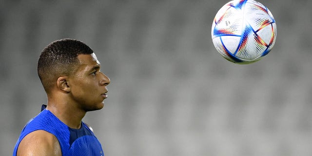 France's forward Kylian Mbappe eyes the ball during a training session at the Jassim-bin-Hamad Stadium in Doha, Qatar, on Nov. 17, 2022, ahead of the Qatar 2022 World Cup football tournament.