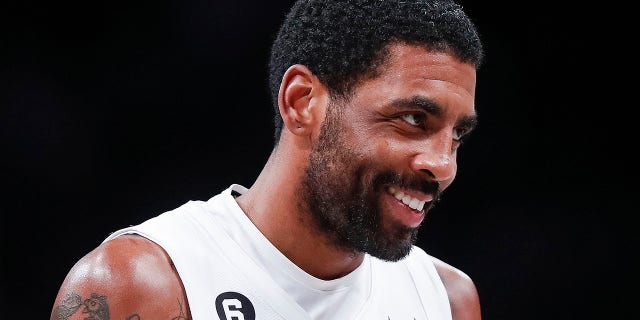 Brooklyn Nets guard Kyrie Irving reacts after scoring against the Memphis Grizzlies, Sunday, Nov. 20, 2022, in New York.