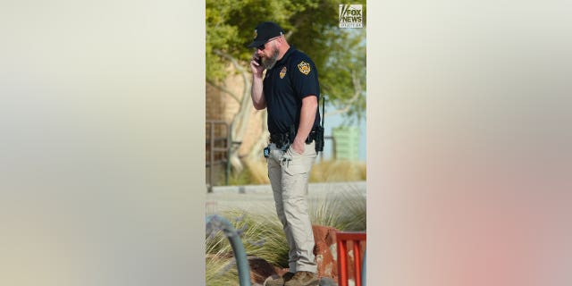 Moab Police officer, Eric Pratt is seen on his phone in Moab Utah, Saturday, October 29, 2022.
