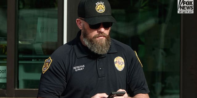 Moab Police officer, Eric Pratt is seen on his phone in Moab Utah, Saturday, October 29, 2022.