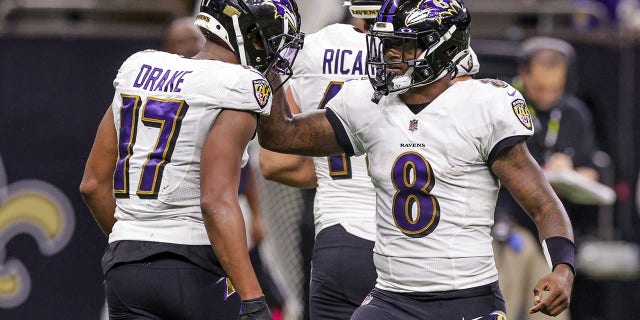 Baltimore Ravens quarterback Lamar Jackson, #8, congratulates running back Kenyan Drake, #17, on scoring a touchdown against the New Orleans Saints during the second half at Caesars Superdome in New Orleans Nov. 7, 2022.
