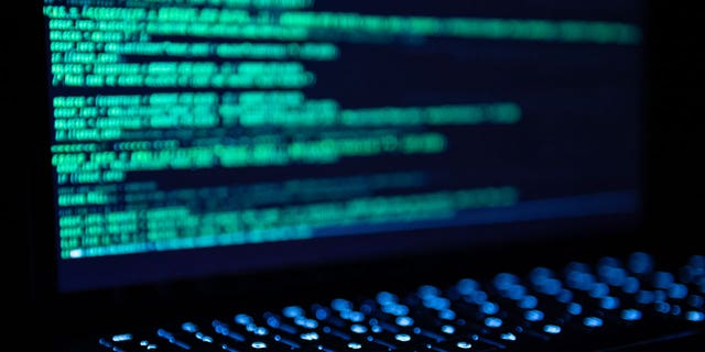 Illustration of a hacker program open on a MacBook Air
