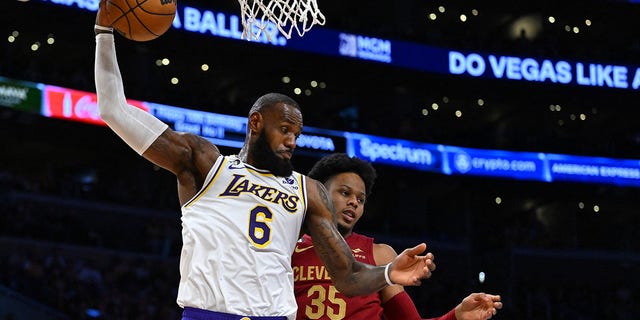 Los Angeles Lakers forward LeBron James (6) grabs a rebound in front of Cleveland Cavaliers forward Isaac Okoro in the first half at Crypto.com Arena on Nov. 6, 2022, in Los Angeles.
