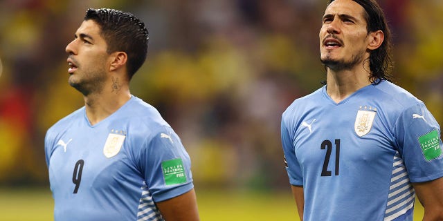 Uruguayan Luis Suarez and Edinson Cavani sing the national anthem before the match between Brazil and Uruguay as part of the Qatar 2022 South American Qualifiers at Arena Amazonia in Manaus, Brazil, on October 14, 2021.