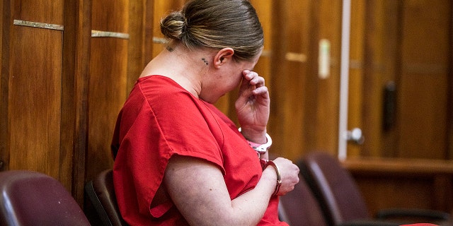 OnlyFans model Courtney Clenney weeps as her 911 call was played during a bond hearing where prosecutors laid out their evidence in detail Nov. 15, 2022.