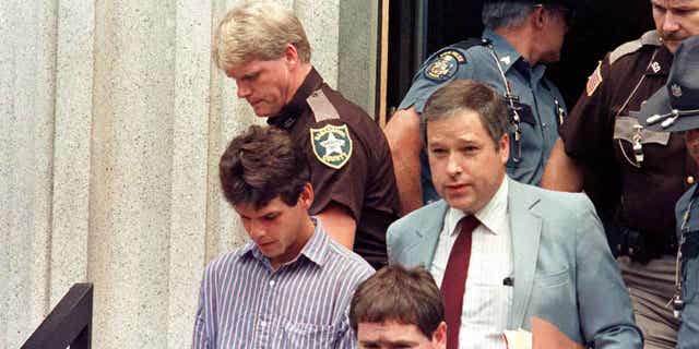 Dennis Dechaine, left, is led out of the Sagadahoc County courthouse, in West Bath, Maine, in August 1988. Dechaine, who was convicted of killing 12-year-old Sarah Cherry, will seek a new trial based on new DNA test results. 