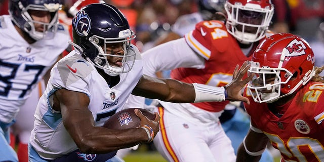 Tennessee Titans quarterback Malik Willis, left, runs with the ball as Kansas City Chiefs safety Justin Reid, right, defends during the second half of an NFL football game Sunday, Nov. 6, 2022, in Kansas City, Missouri. 