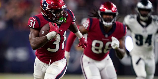 Philadelphia Eagles cornerback Mario Goodrich (31) carries for a long gain in the first half of an NFL football game against the Philadelphia Eagles in Houston, Thursday, Nov. 3, 2022.