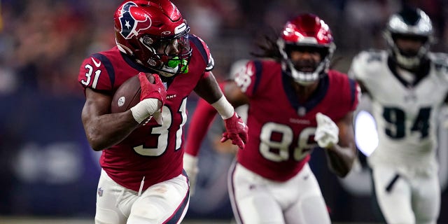 Philadelphia Eagles cornerback Mario Goodrich (31) carries for a long gain in the first half of an NFL football game against the Philadelphia Eagles in Houston, Thursday, Nov. 3, 2022.