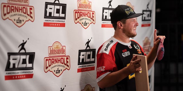 Mark Richards has his picture taken after winning the final match of the American Cornhole League Pro Singles World Championship finals at the Rock Hill Sports and Event Center in Rock Hill, South Carolina, Aug. 6, 2022.