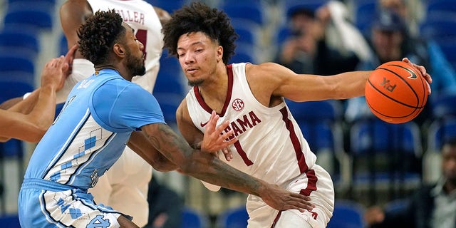 North Carolina forward Leaky Black, left, defends against Alabama guard Mark Sears, right, during the first half of an NCAA college basketball game at the Phil Knight Invitational on Sunday, Nov. 27, 2022, in Portland, Oregon.
