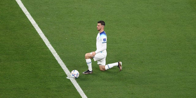 Mason Mount of England takes a knee before a FIFA World Cup Qatar 2022 Group B match against the U.S. at Al Bayt Stadium Nov. 25, 2022, in Al Khor, Qatar.