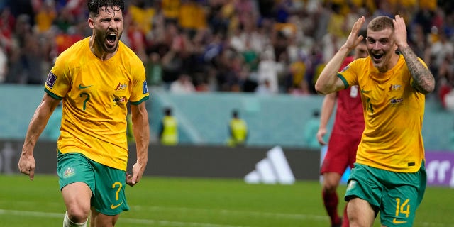 Australia's Mathew Leckie, left, celebrates with teammate Riley McGree after scoring his team's first goal during the World Cup Group D soccer match between Australia and Denmark, at the Al Janoub Stadium in Al Wakrah, Qatar, on Wednesday, November 30, 2022. 