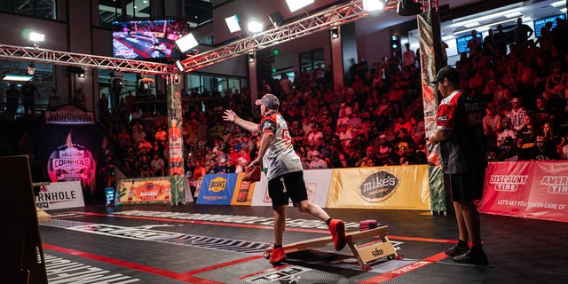 Matt Guy (center) makes his throw against Mark Richards (right) during the final match of the American Cornhole League Pro Singles World Championship finals at the Rock Hill Sports and Event Center in Rock Hill, South Carolina, Aug. 6, 2022. Richards eventually get the better of Guy, taking top honors in the final competition.