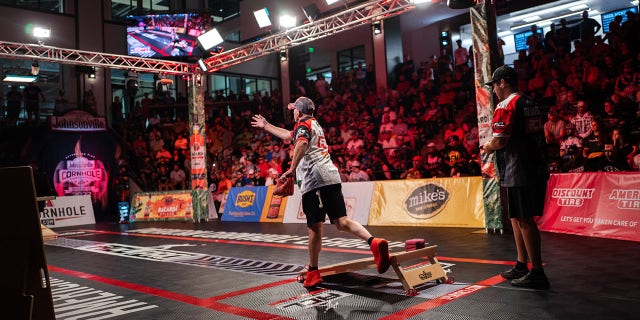 Matt Guy (center) makes his throw against Mark Richards (right) during the final match of the American Cornhole League Pro Singles World Championship finals at the Rock Hill Sports and Event Center in Rock Hill, South Carolina, Aug. 6, 2022. Richards eventually get the better of Guy, taking top honors in the final competition.