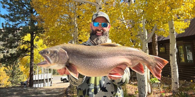 Matt Smiley, an angler from Lake City, Colorado, holds up his record-breaking brook trout, which he caught from Waterdog Lake on Oct. 8, 2022.
