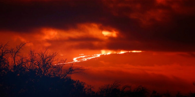 A river of lava flows down from Mauna Loa, Monday, Nov. 28, 2022, near Hilo, Hawaii. 