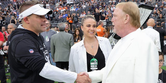 LAS VEGAS, NEVADA - OCTOBER 2: (LR) Las Vegas Raiders Head Coach Josh McDaniels, Las Vegas Aces Head Coach Becky Hyman and Raiders Owner and Managing General Partner Mark Davis talk on the Raiders sideline in front of the team. game against the Denver Broncos at Allegiant Stadium on October 2, 2022 in Las Vegas, Nevada. The Raiders defeated the Broncos 32–23.