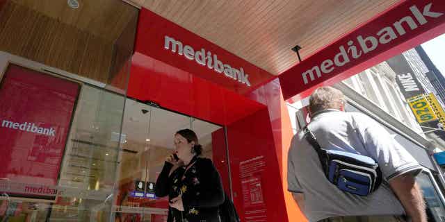 People walk past a Medibank branch in Sydney on November 11, 2022. Extortionists have dumped personal medical records on the dark web for a third day as they pressure Australia's largest health insurer to pay a ransom.