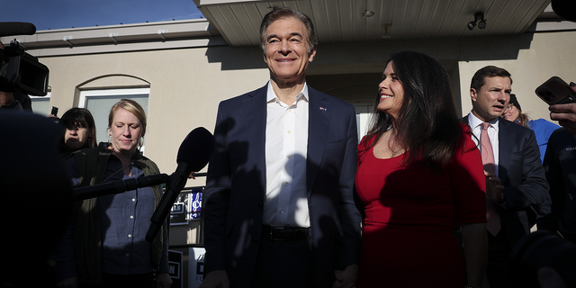 Republican U.S. Senate candidate Dr. Mehmet Oz answers brief questions with his wife Lisa Oz after casting his ballot at the Bryn Athyn Borough Hall on Nov. 8 in Huntingdon Valley, Pennsylvania.