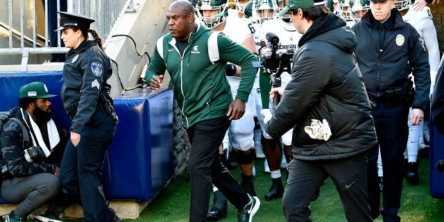 Michigan State head coach Mel Tucker leads the team through the tunnel onto the field with two police escorts during the Michigan State Spartans versus Penn State Nittany Lions game on November 26, 2022 at Beaver Stadium in University Park, PA.