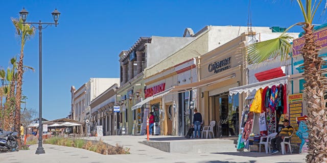 In Mexico, a tourist was killed on Oct. 29 who was seen in a viral video being beaten. Prosecutors investigating the death of the woman said she died from a severe spinal cord injury. Pictured: Pharmacies and souvenir shops in the city centre of San Jose del Cabo on the peninsula of Baja California Sur, Mexico.