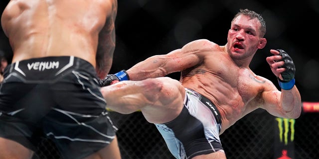 Michael Chandler kicks Dustin Poirier during their lightweight bout on Nov. 12, 2022, in Madison Square Garden.