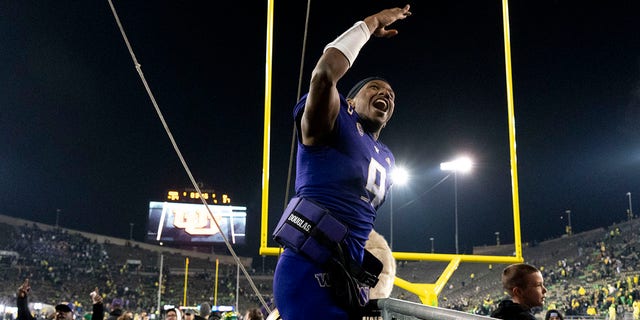 Washington quarterback Michael Penix Jr., #9, celebrates as he leaves Autzen Stadium after defeating Oregon in an NCAA college football game Saturday, Nov. 12, 2022, in Eugene, Oregon.