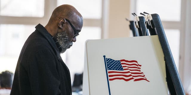 A voter casts a ballot at a polling station in Detroit March 10, 2020.