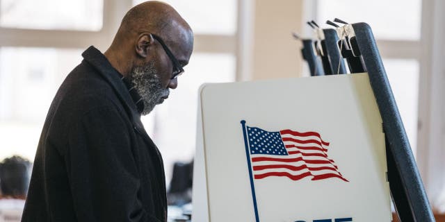 A voter casts a ballot at a polling station in Detroit March 10, 2020.