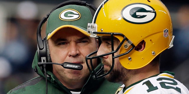 Green Bay Packers head coach Mike McCarthy talks to quarterback Aaron Rodgers (12) during the first half of the NFC Championship game against the Seattle Seahawks in Seattle Jan. 18, 2015. 