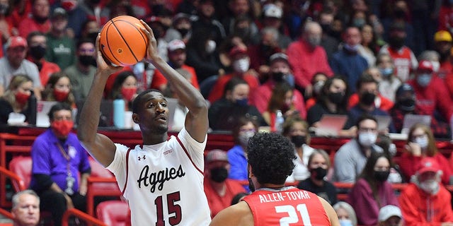 Mike Peake #15 of the New Mexico State Aggies looks to pass against Jay Allen-Tovar #21 of the New Mexico Lobos during their game at The Pit on December 6, 2021 in Albuquerque, New Mexico.  