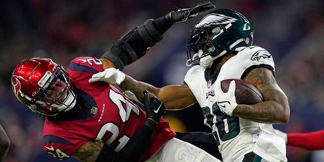 Philadelphia Eagles running back Miles Sanders (26) carries against Houston Texans cornerback Derek Stingley Jr. (24) in the first half of an NFL football game in Houston, Thursday, Nov. 3, 2022. 