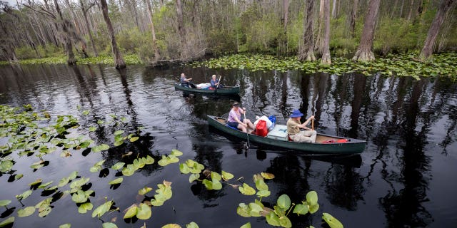 A group of visitors return to Stephen C. Foster State Park after an overnight camping trip on the Red Trail in the Okefenokee National Wildlife Refuge, on April 6, 2022, in Fargo, GA.