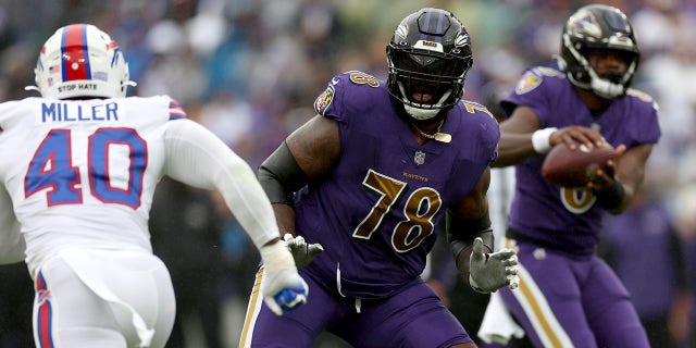 Baltimore Ravens offensive tackle Morgan Moses, center, blocks Buffalo Bills linebacker Von Miller at M&T Bank Stadium in Baltimore, Maryland on October 2, 2022.