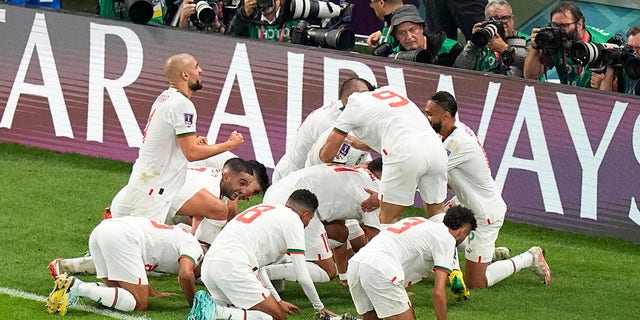 The Moroccan team celebrates their first goal against Belgium during the World Cup at the Al Thumama Stadium in Doha, Qatar, Sunday, Nov. 27, 2022.