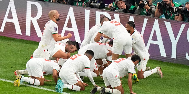 The Moroccan team celebrates their first goal against Belgium during the World Cup at the Al Thumama Stadium in Doha, Qatar, Sunday, Nov. 27, 2022.