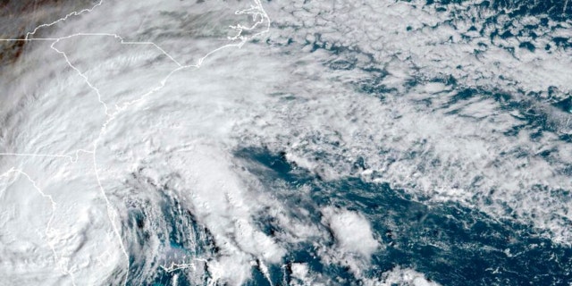 This satellite image provided by NOAA shows Tropical Storm Nicole making landfall as a hurricane early Thursday, November 10, 2022, near Florida.