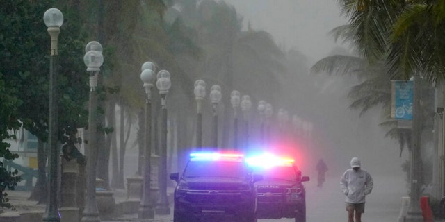 Police patrol the Hollywood Beach Boardwalk as conditions deteriorate with the approach of Hurricane Nicole, Wednesday, Nov. 9, 2022, in Hollywood Beach in Hollywood, Fla. 