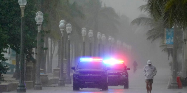 Police patrol the Hollywood Beach Boardwalk as conditions deteriorate with the approach of Hurricane Nicole, Wednesday, Nov. 9, 2022, in Hollywood Beach in Hollywood, Fla.