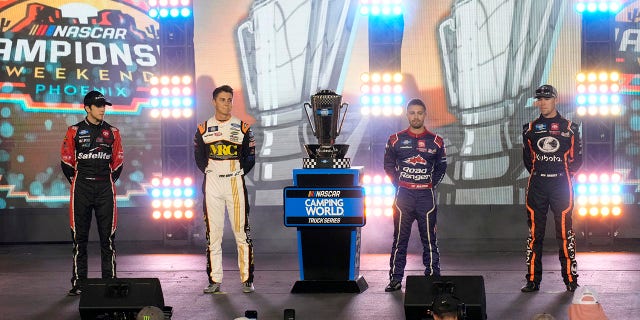 Chandler Smith, Zane Smith, Ty Majeski and Ben Rhodes, from left, pose with the trophy before the NASCAR Truck Series auto race Friday, Nov. 4, 2022, in Avondale.