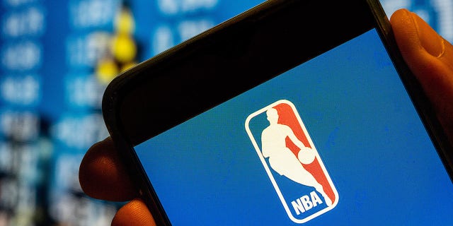“Jab or Job”: NBA Refs Claim They Were Fired for Refusing COVID Vax 4 National Basketball Association logo is displayed on a smartphone screen.