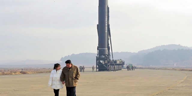 In this photo provided by the North Korean government on Nov. 19, 2022, North Korean leader Kim Jong Un, right, and his daughter are seen inspecting a missile launch site at Pyongyang International Airport in Pyongyang, North Korea, Friday, Nov. 18.  , 2022.