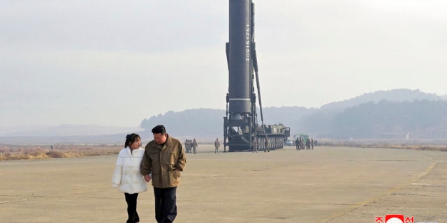 This photo provided on Nov. 19, 2022, by the North Korean government shows North Korean leader Kim Jong Un, right, and his daughter inspect the site of a missile launch at Pyongyang International Airport in Pyongyang, North Korea, Friday, Nov. 18, 2022.