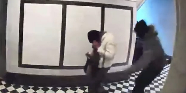 The woman is first seen being approached from behind inside an apartment building in the vicinity of East Mosholu Parkway North and Kossuth Avenue.