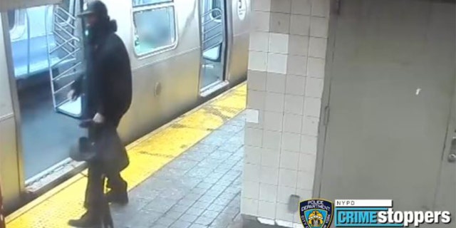 Surveillance footage from NYPD showing the fight spill onto the subway platform. 